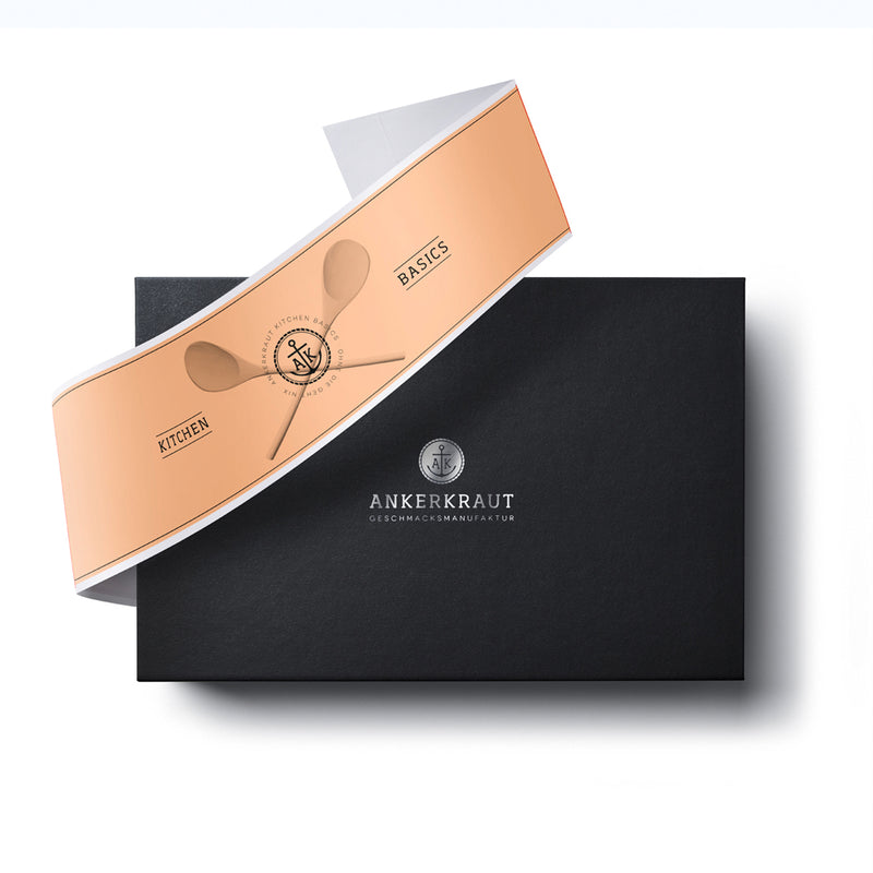 Kitchen basics Geschenk-Box aus schwarzem Karton mit diagonaler Banderole.